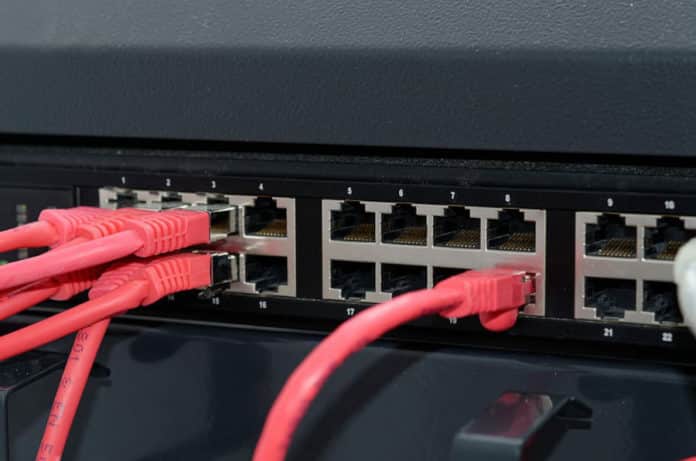Cables connect to ports in a network router.